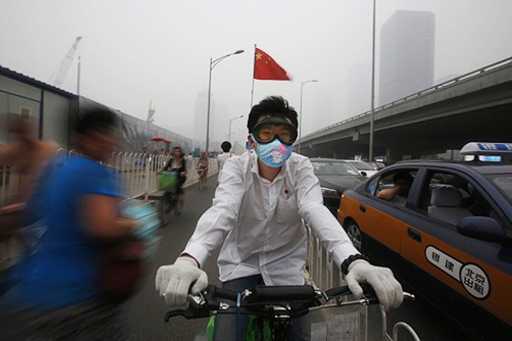 Face masks are visible in many places outside in Beijing as smog reaches dangerous levels. Photo: EPA