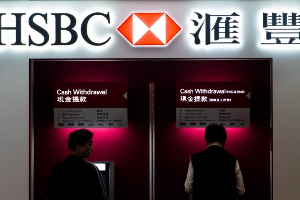 Two men use ATM machines at an HSBC branch in Hong Kong. Photo: AFP