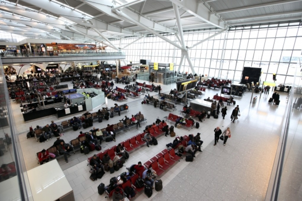 Passengers wait in the departures lounge at Terminal 5 of Heathrow airport in London. Photo: Bloomberg