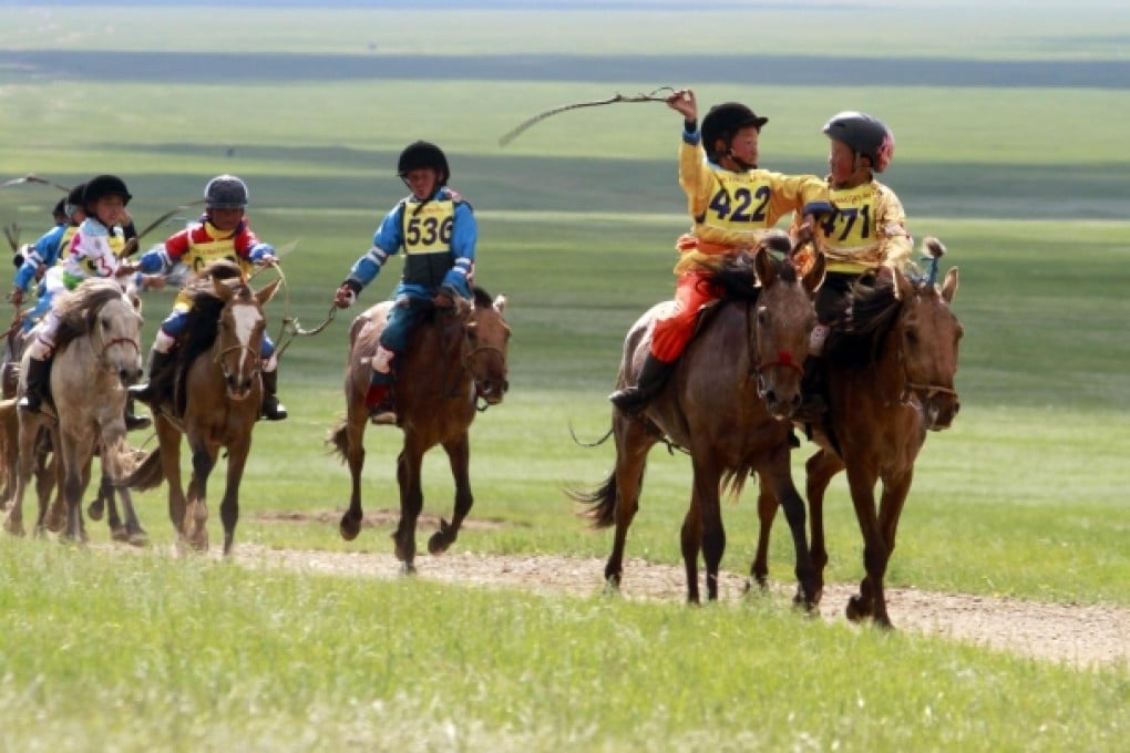 Children take part in a race during the Naadam festival in Ulan Bator. Controversy is growing over the way unprotected young riders are risking injury and even death.Photo: AFP
