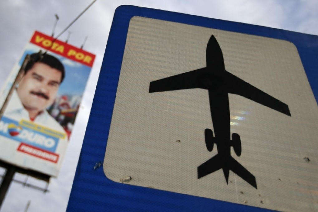 A sign points the way to Venezuela's Caracas airport, which would be the final destination for Edward Snowden should he accept that country's offer of asylum. Photo: Reuters