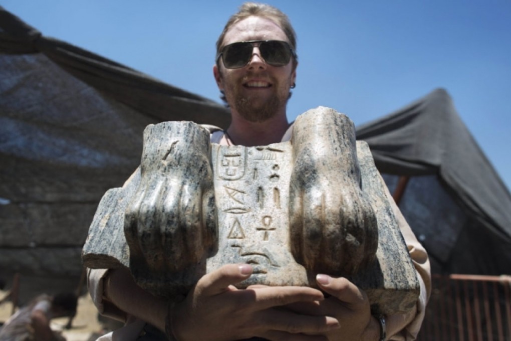 A worker displays parts of the sphinx at Tel Hazor. Photo: AFP