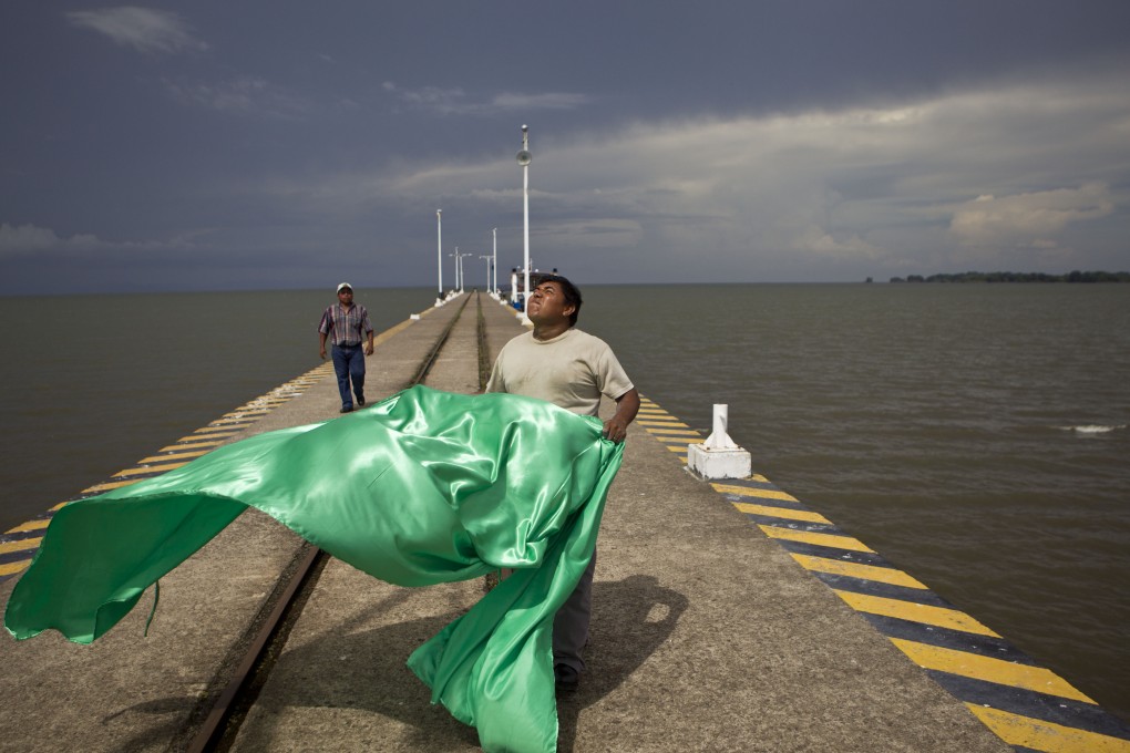 A worker at Cocibolca Lake, one of the most important reserves of freshwater in the Americas. A planned canal may put the lake's ecological system at risk. Photo: AP