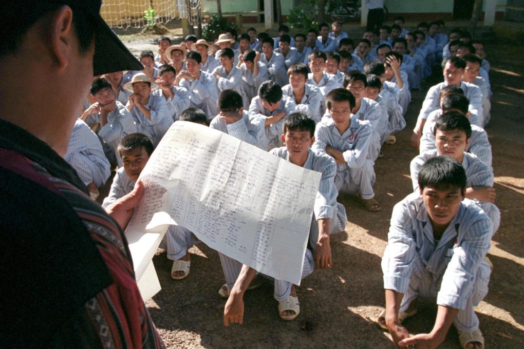 Vietnamese heroin addicts squat in a courtyard at a re-education centre near Hanoi. A Vietnamese court sentenced four men to death for dealing in heroin. Photo: Reuters