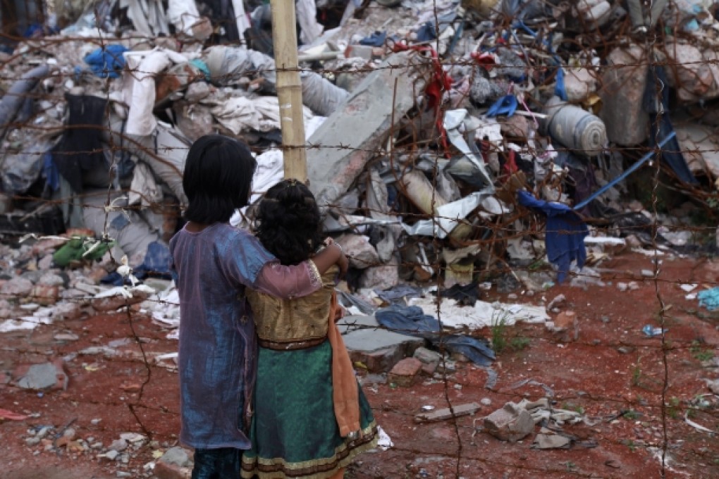 Two children look at the rubble after the Rana Plaza building collapse in Bangladesh. Photo: EPA