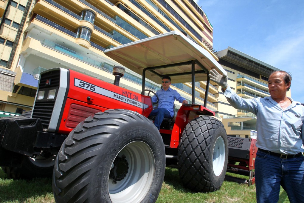 Sin Zai (on the tractor), who maintains the Happy Valley racecourse turf, thrives on seeing the audience enjoy themselves during the races. Photo: Jonathan Wong