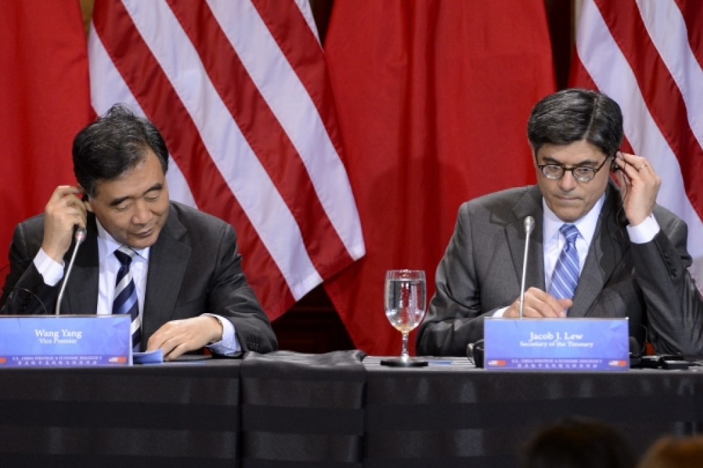 Wang Yang, Chinese vice premier (left) and US Treasury Secretary Jack Lew listen to translation devices during the closing session of high-level Sino-US talks on Thursday. Photo: EPA