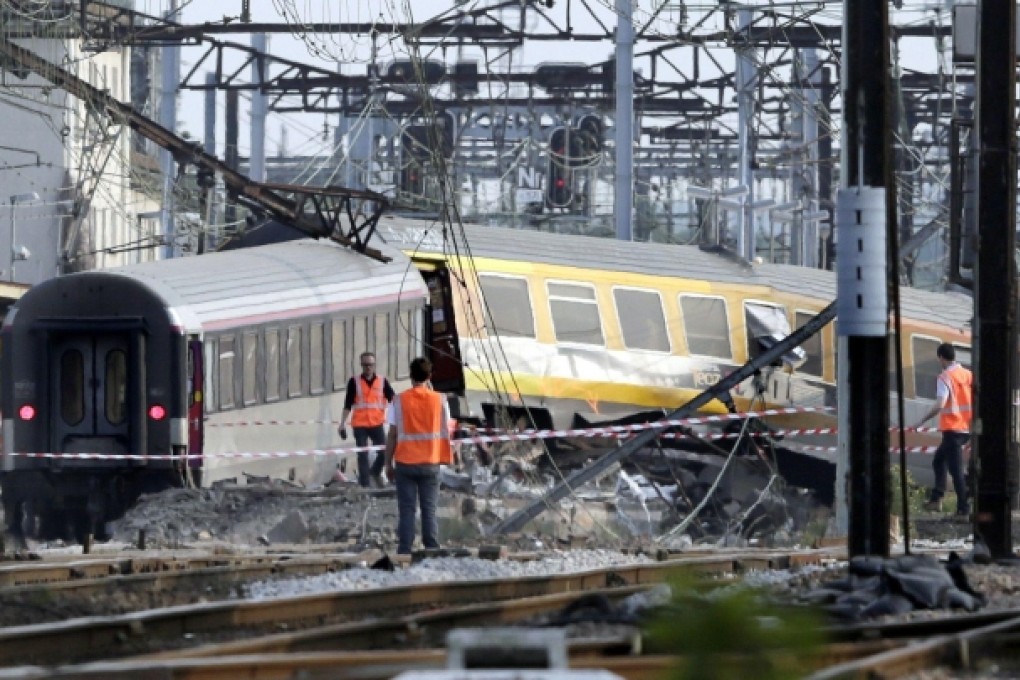 Rescuers search for victims among the wreckage of Friday's train crash near Paris. At least six people died and 30 were injured. Photo: AFP