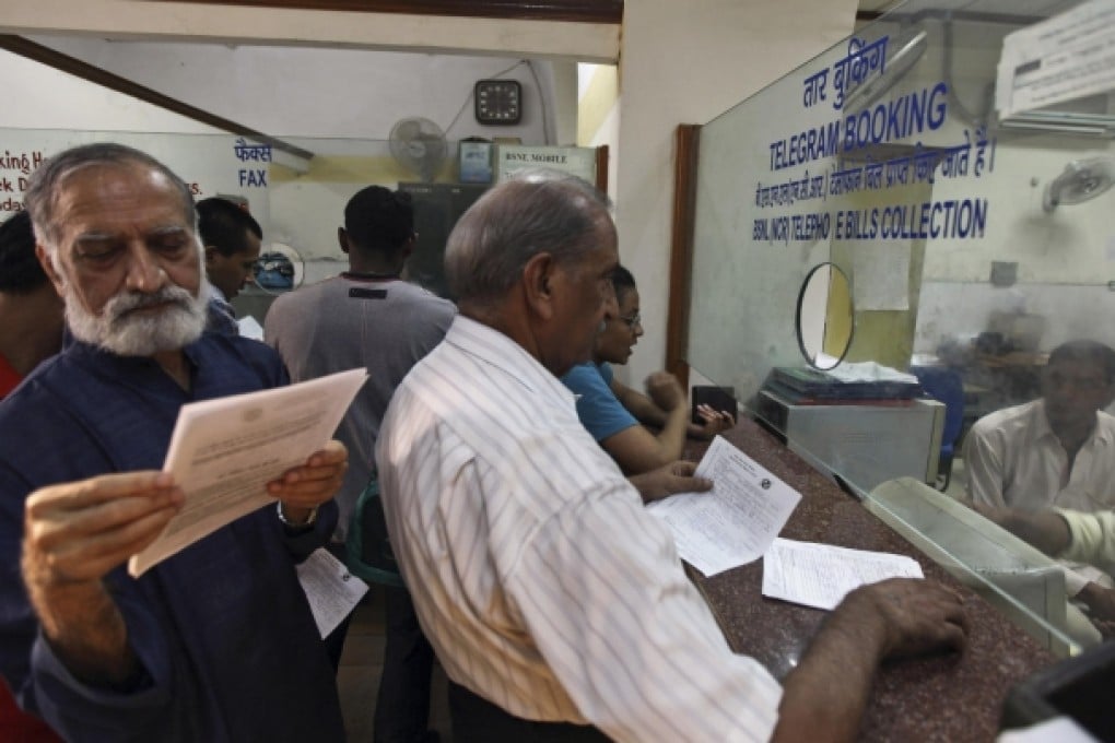 People queue to send telegrams at the Central Telegraph Office in New Delhi before the service is closed down amid losses. Photo: AP
