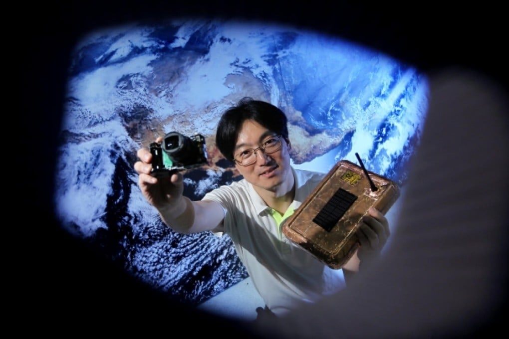 Ricky Fan, president of the Environmental Protection Association, shows the camera that travelled to an altitude of more than nine kilometres on a test flight. Photo: Felix Wong
