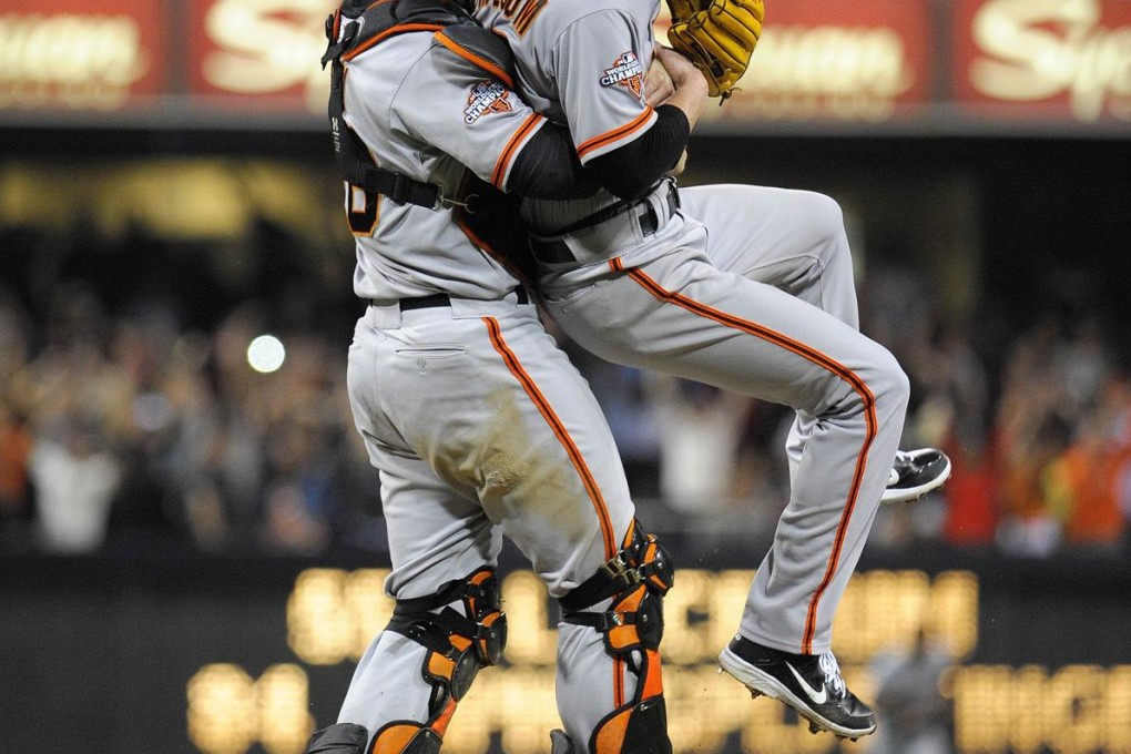 Tim Lincecum is lifted by Buster Posey after pitching his first career no-hitter. Photo: AFP
