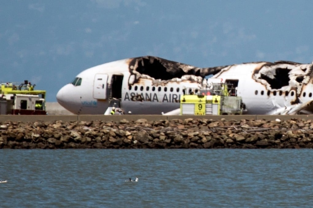 The burned Boeing 777, operated by Asiana Airlines, sits on the runway after it crashed landed at San Francisco International Airport. Photo: Bloomberg