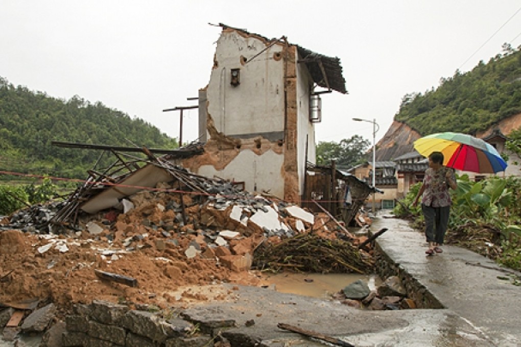 A villager walks past a house destroyed by Typhoon Soulik in Liandun village, Meizhou city, south China's Guangdong province, on Sunday. Photo: AP
