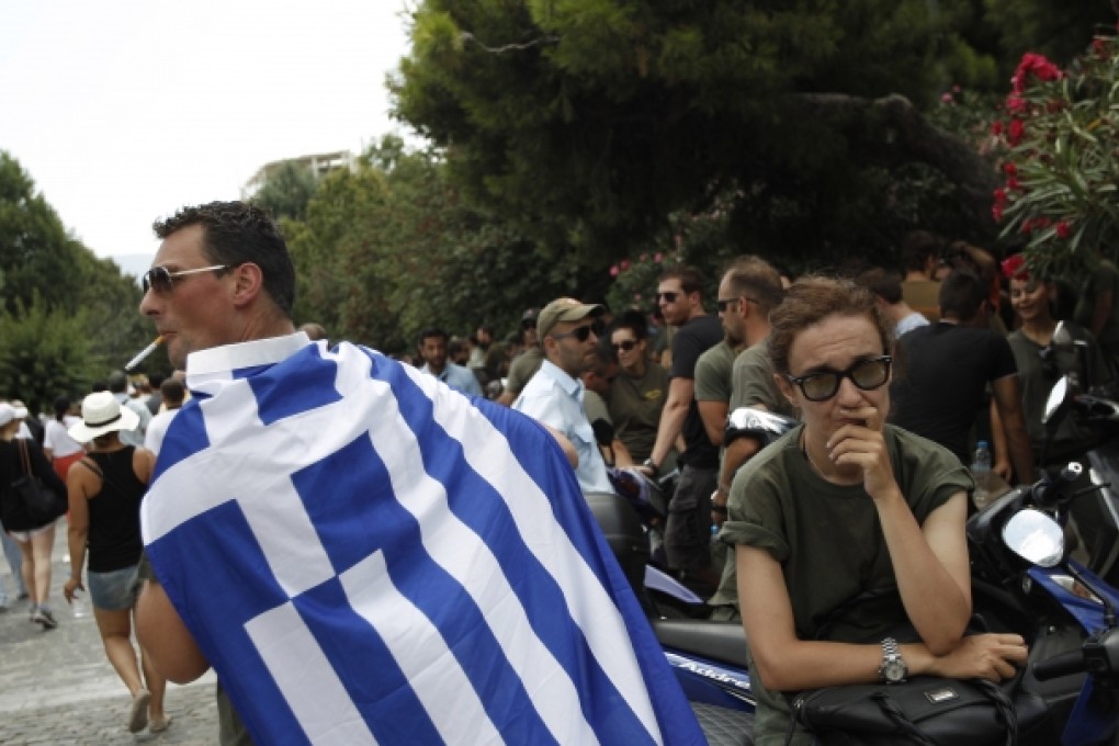 Striking municipal police officers protest austerity cuts that will affect thousands of public sector workers in Athens on Saturday. The government has committed to major job cuts in return for EU-IMF aid. Photo: AP