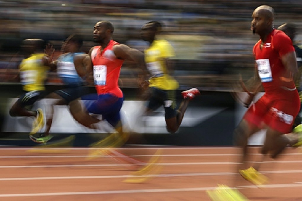 Tyson Gay (centre) and Asafa Powell (right) compete during the mens 100m race at the Athletissima athletics meeting in Switzerland on July 4. Photo: EPA