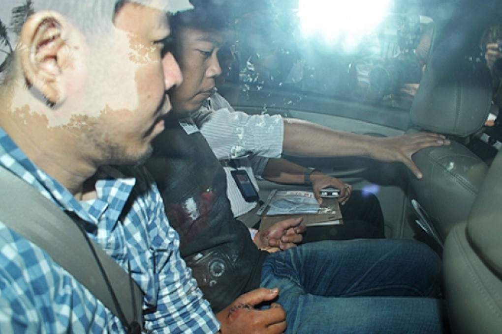 Iskandar Rahmat (centre) leaves a Singapore court on Monday. Photo: AFP