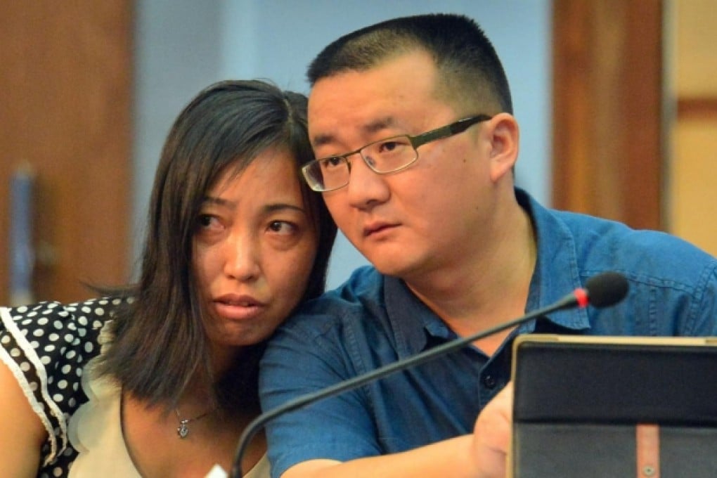 Tang Hui and her lawyer in court, where they heard the judges award her damages. Photo: AFP