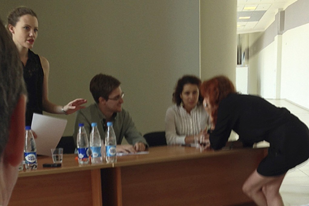 Former intelligence agency contractor Edward Snowden speaks to human rights representatives in Moscow's Sheremetyevo airport. Photo: Reuters