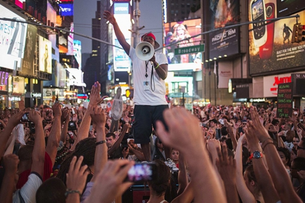 Thousands of protesters in Times Square, New York, call for federal authorities to pursue a civil rights action against George Zimmerman after his acquittal over the killing of Trayvon Martin. Photo: Reuters