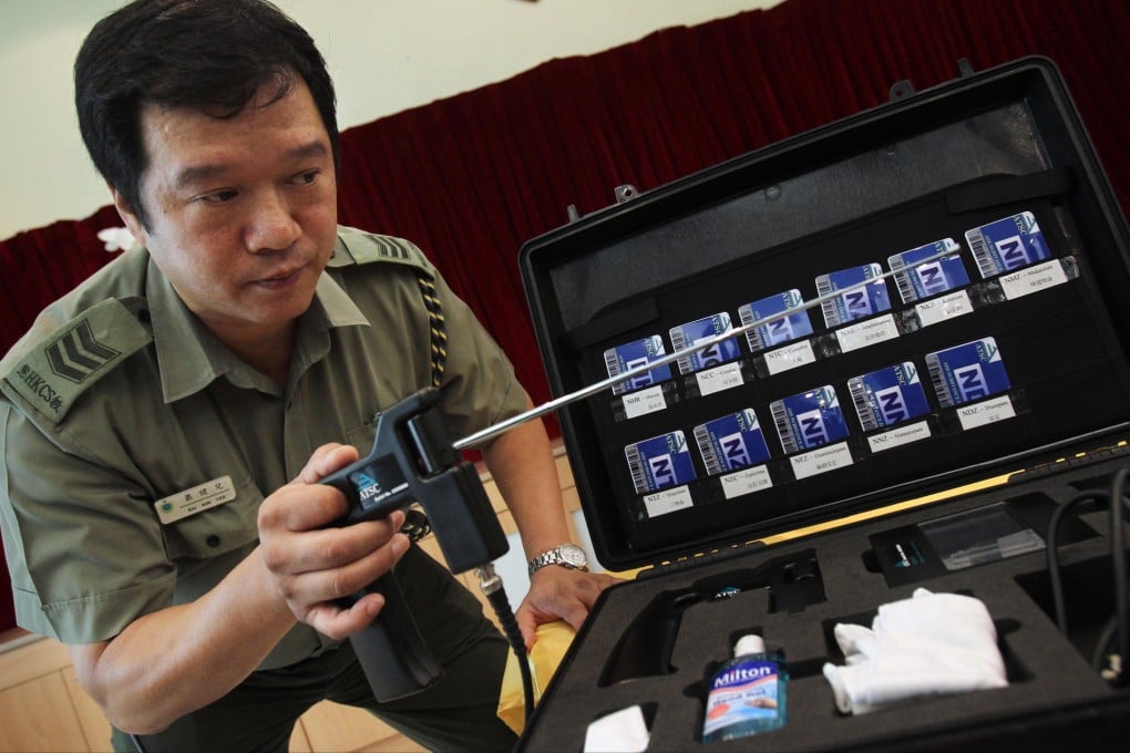 A corrections officer Siu Kin-yee demonstrates the drug detector in 2010 that conman James McCormick, jailed in May this year, sold to the department. Photo: David Wong