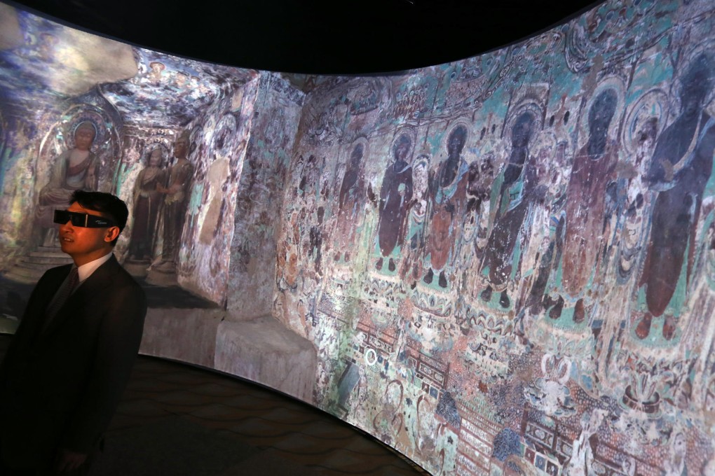 A visitor views the Mogao Grottoes projection. Photo: Sam Tsang