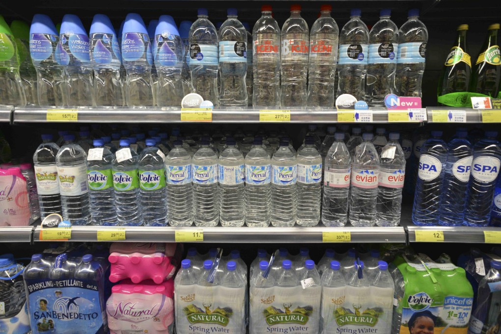 Bottles of imported water line a supermarket shelf in the city, offering a choice of products that probably all taste the same.