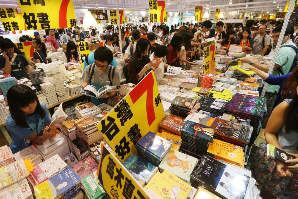 Happy readers check out the bargains among books from Taiwan at the Hong Kong Book Fair yesterday. Photo: Sam Tsang
