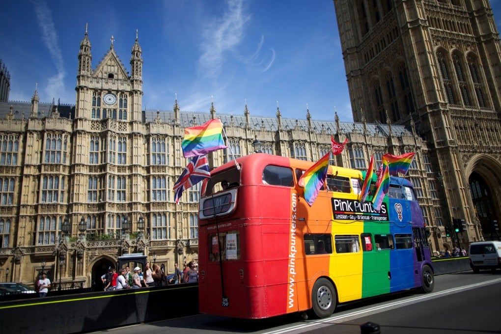 Gay campaigners drive a bus past the Houses of Parliament in London on Monday. Photo: AFP