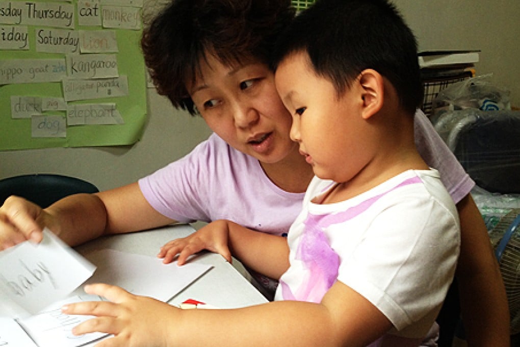 Yu Jun teaches her daughter English at home in Beijing. She said she is prepared to home-school Yueyue if she doesn't get legal identification to go to school. Photo: Wu Nan