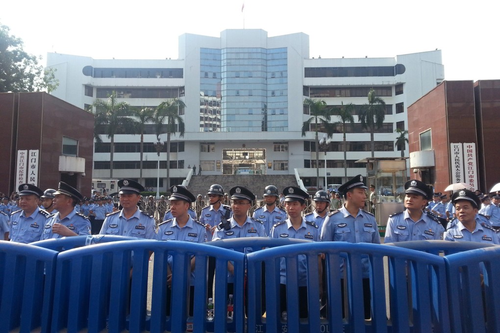 Police stand guard during a protest against plans for a uranium processing plant in Jiangmen city, Guangdong province, on Friday. Photo: Reuters
