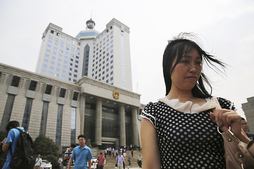 Tang Hui stands outside a court in Changsha, Hunan province, on Monday. Photo: Reuters