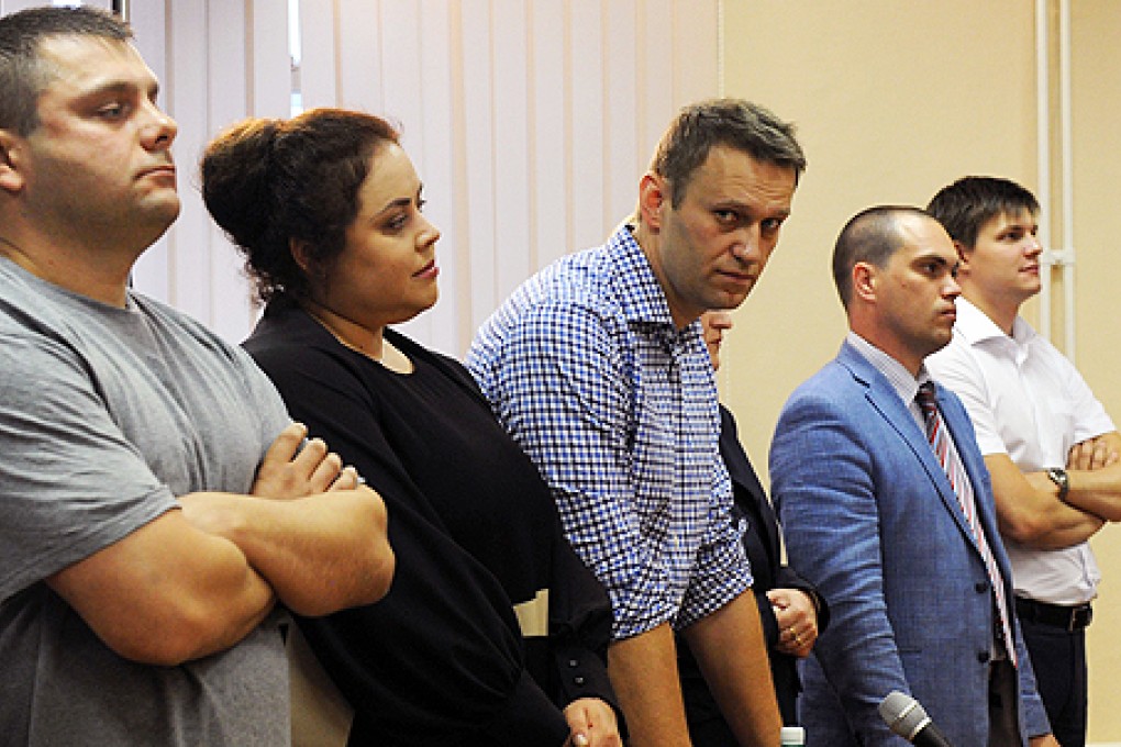Russia's top opposition leader Alexei Navalny (centre) stands in a courtroom in Kirov on Thursday as the verdict in his embezzlement trial is delivered. Photo: AFP