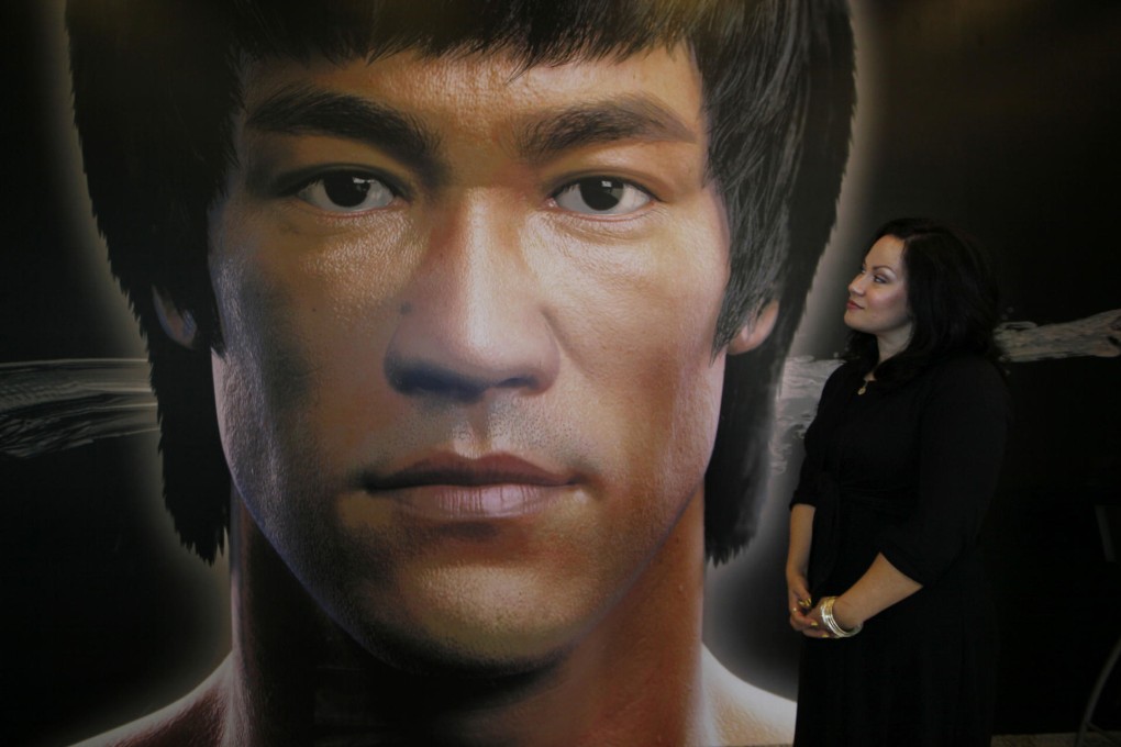 Bruce Lee's daughter Shannon with a poster promoting her father's memorial exhibition at the Heritage Museum in Sha Tin. Photo: AP