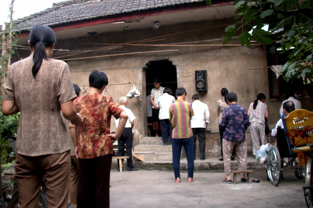 Villagers stand during a prayer at a rural Christian church in Wuhu, Anhui Province. Photo: EPA