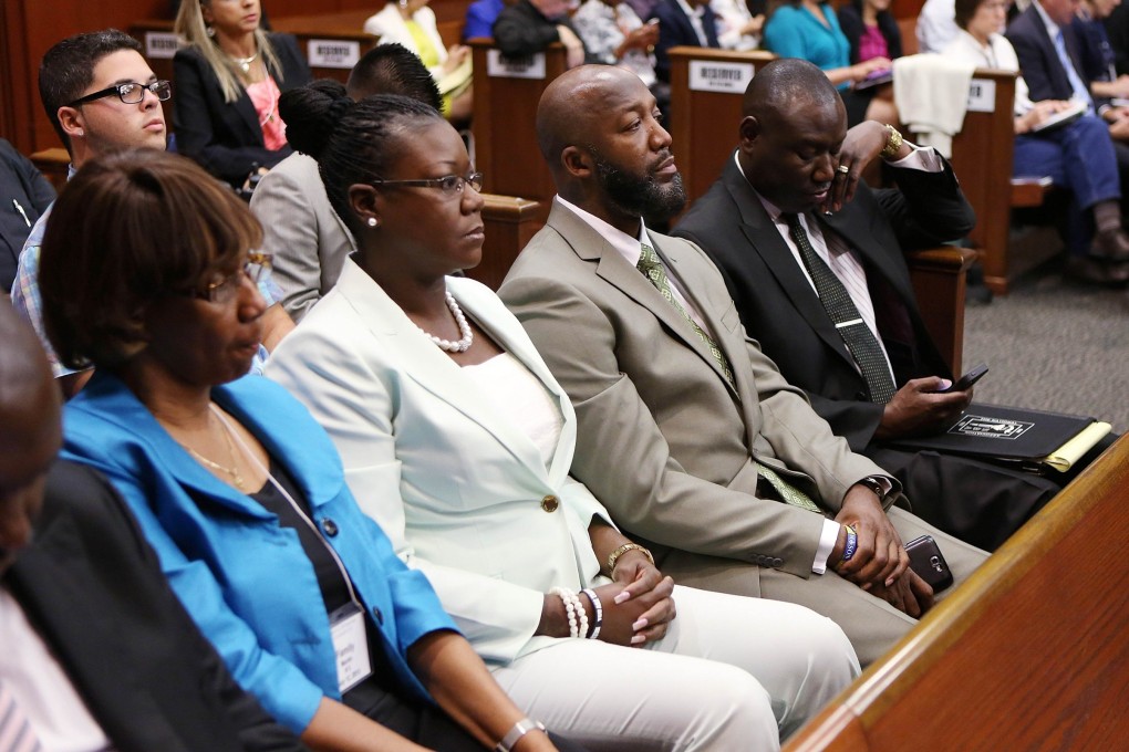 Sybrina Fulton (2nd left) and Tracy Martin (3rd left), Trayvon Martin's parents, and family lawyer Benjamin Crump (4th left) sit in court during George Zimmerman's murder trial. Photo: AFP