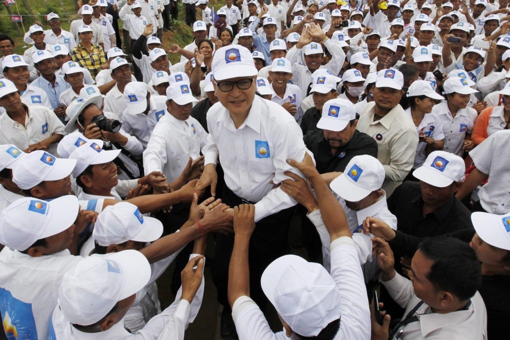 Opposition leader Sam Rainsy greets supporters during a rally in Kampong Speu province yesterday. Photo: EPA