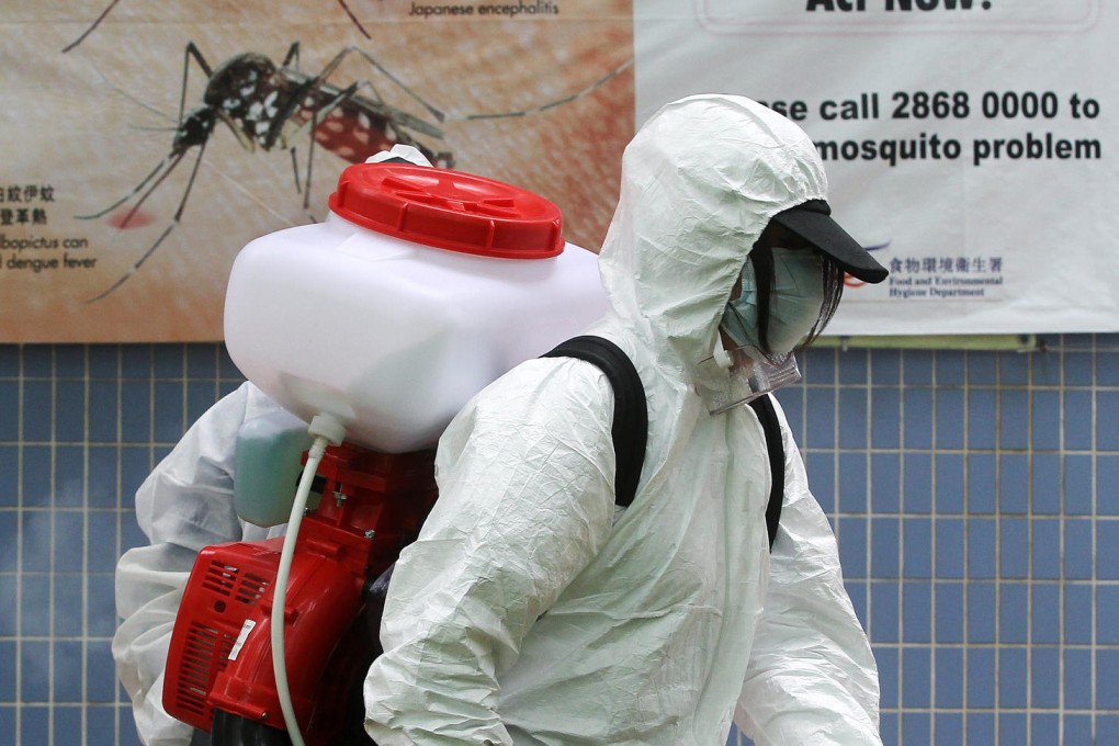 A Food and Environmental Hygiene Department worker prepares to spray aerosol to kill mosquitoes in Tin Shui Wai. Photo: K.Y. Cheng