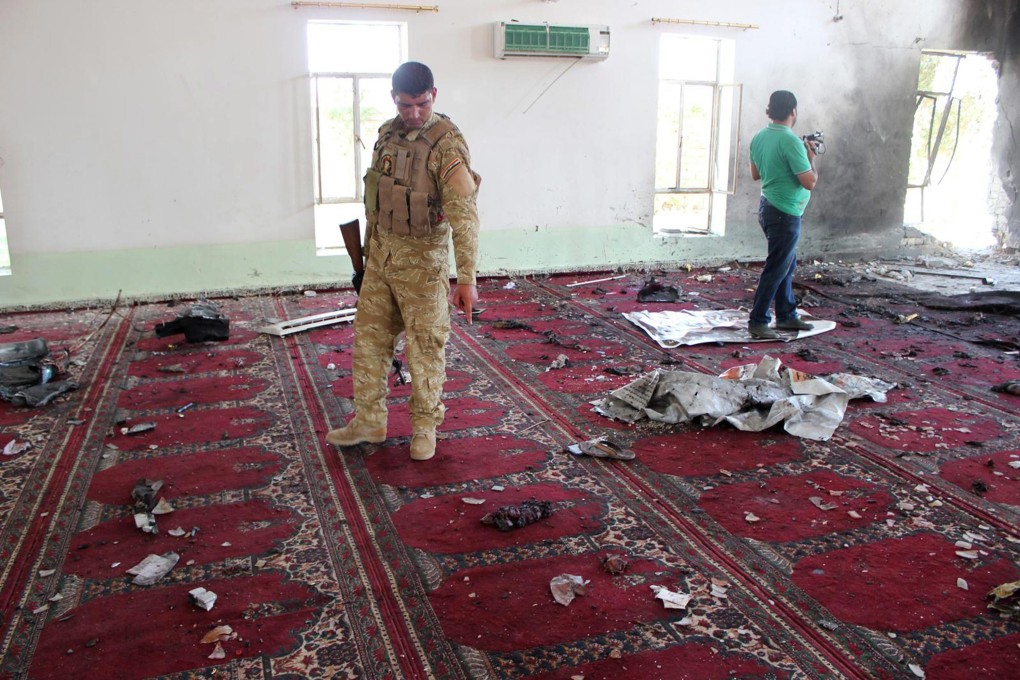 An Iraqi soldier inspects the site of a bomb attack inside a mosque in Baquba city, northeast of Baghdad. At least 15 people were killed and 65 injured in a bomb explosion that targeted a Sunni mosque in Iraq, security officials said. Photo: EPA