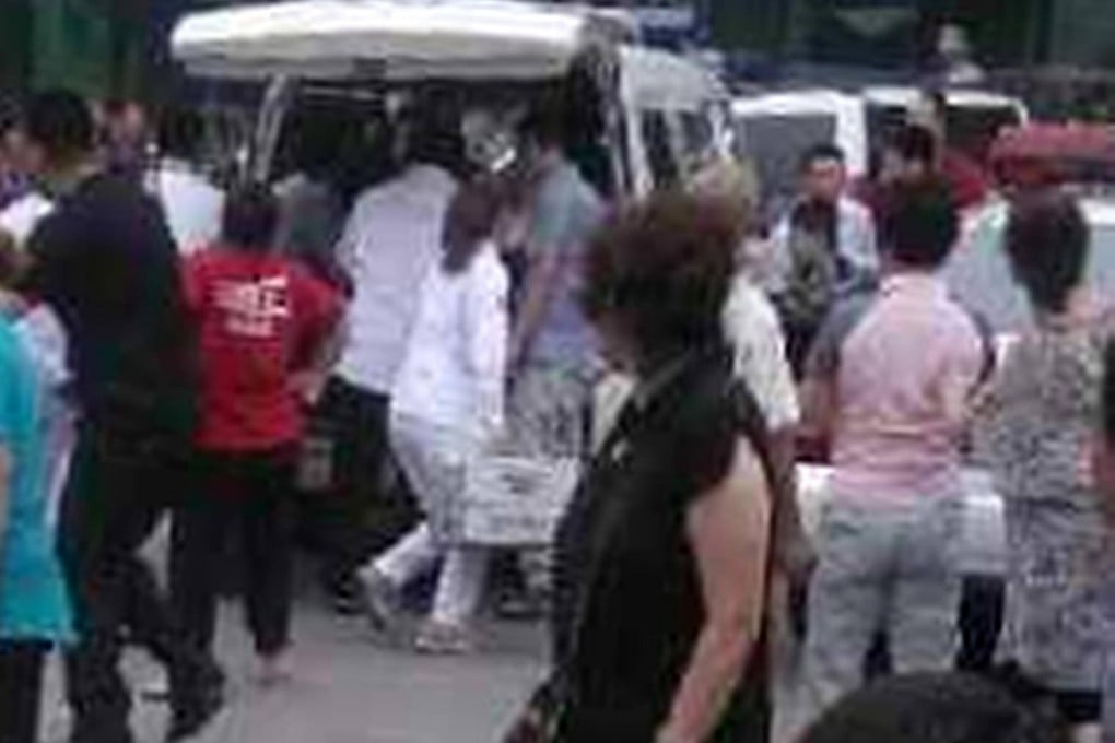 Ambulance staff tend the injured. Photo: SCMP