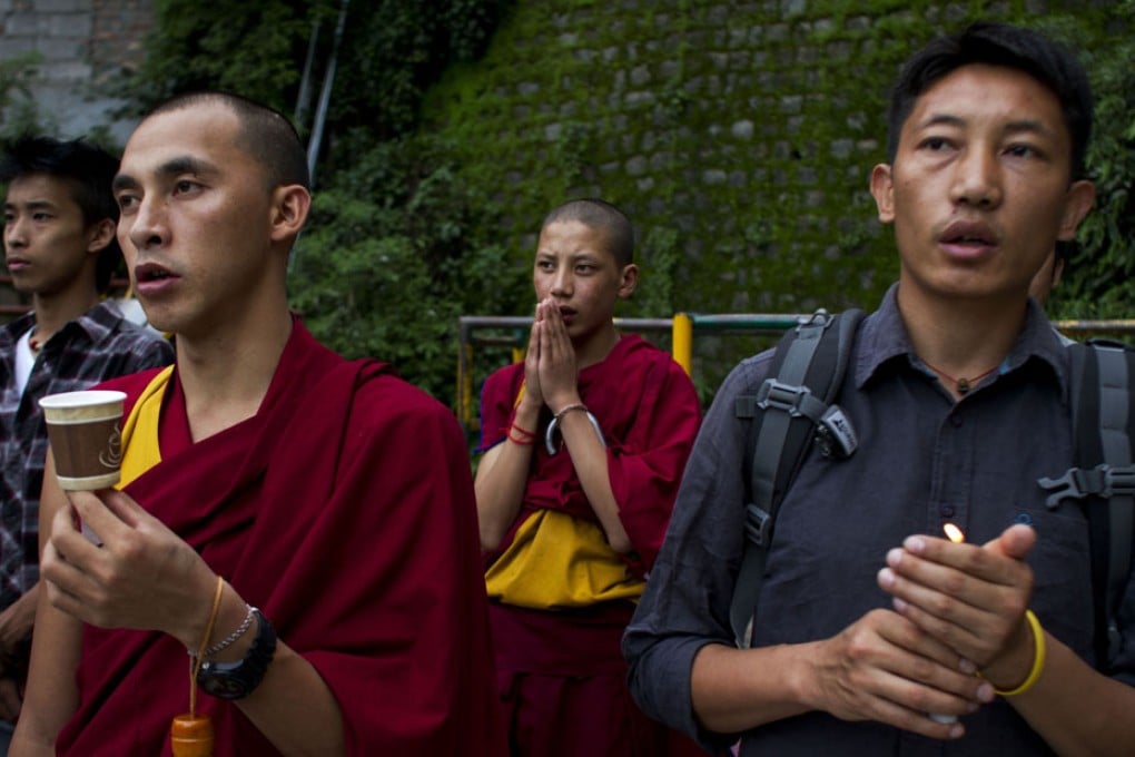Exile Tibetans pray as they hold a candlelit vigil upon hearing the news of a self-immolation by a Tibetan Buddhist monk. Photo: AP