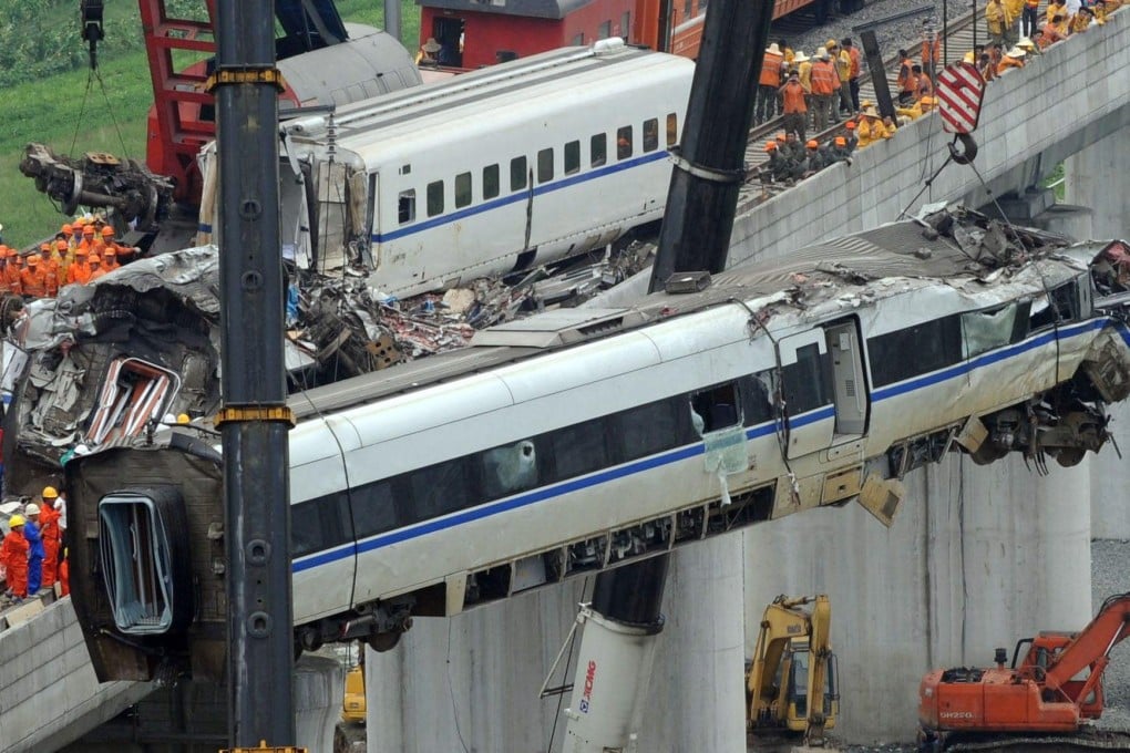 Wrecked carriages are cleared from the track. Photo: AFP