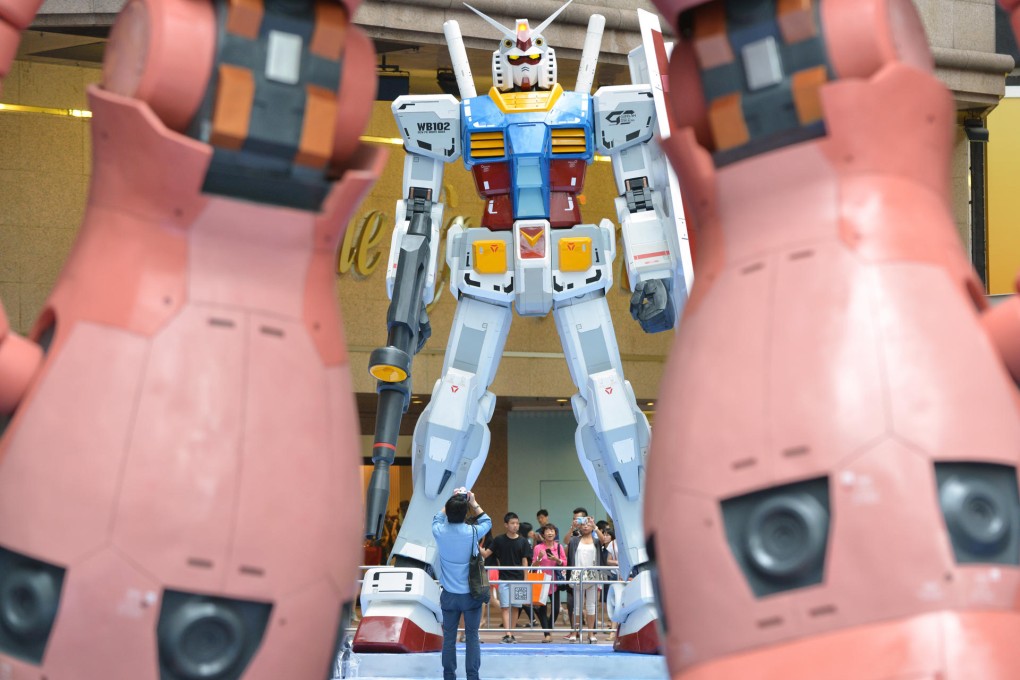 Mock-ups of giant anime robots at Times Square tower over visitors in a display that will last for more than two months. Photo: Thomas Yau