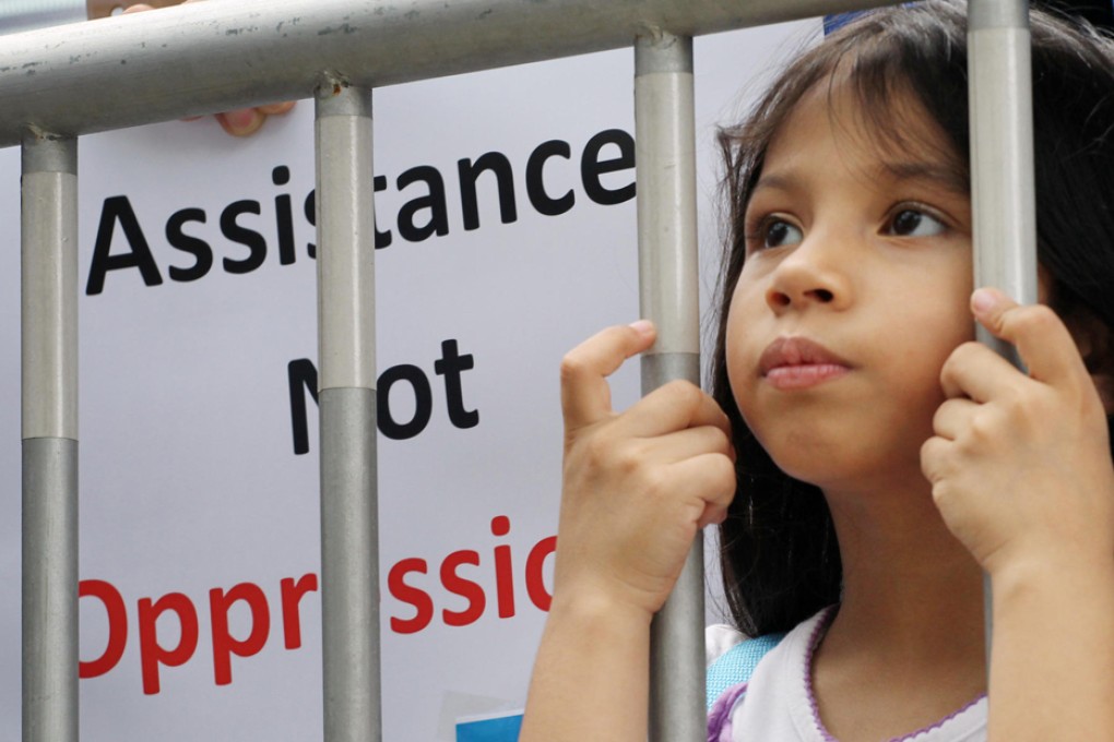 Ameena Butt, seven, joins the protest outside Legco. Her father fled Pakistan after switching to Christianity in 2008. Photo: Felix Wong