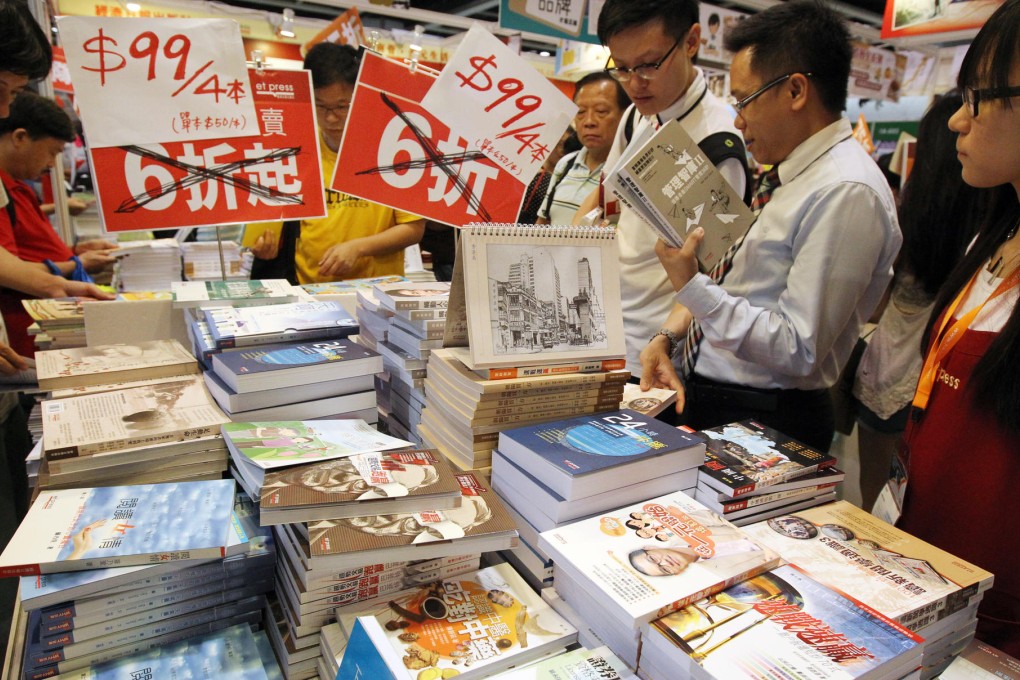 Visitors scour the tables for last-day bargains. Photo: Dickson Lee