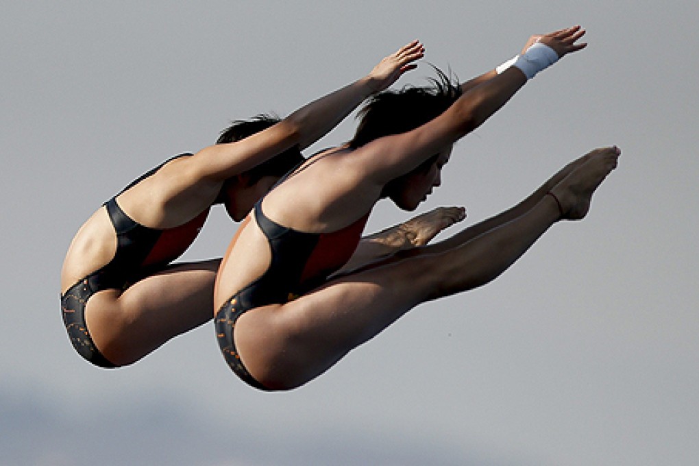Chen Ruolin and Liu Huixia in the women's 10-metre synchro platform diving final. Photo: EPA