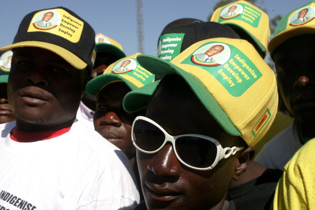 Mugabe supporters at a rally in Chitungwiza. Senior party figures are accused of hoarding campaign regalia.Photo: AFP