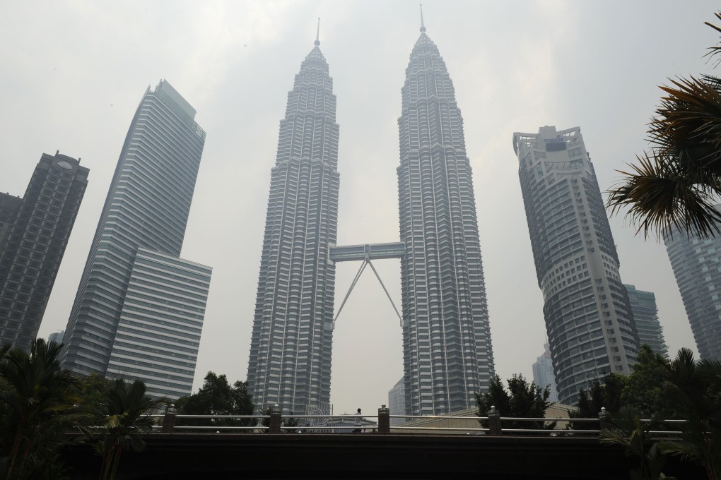 Malaysia's landmark Petronas Twin Towers (centre) are covered with light haze in Kuala Lumpur. Photo: AFP