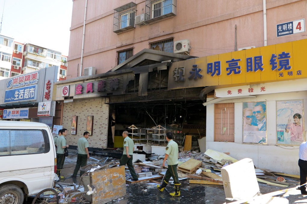 Firemen work at the explosion site of a cake shop on Guangming Road in Beijing. Photo: Xinhua