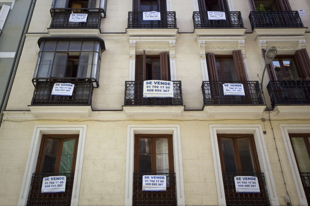 For sale signs festoon a Madrid building. The market shows no signs of recovering since the property bubble burst during the global financial crisis. Photo: Reuters