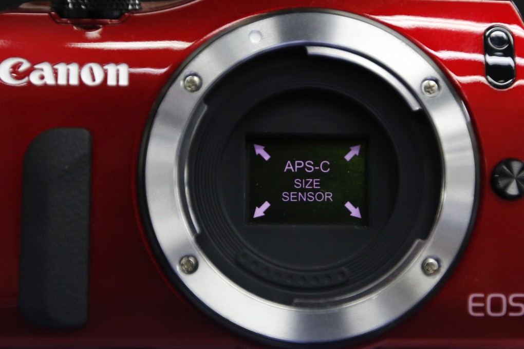 Canon lowers full-year profit forecast